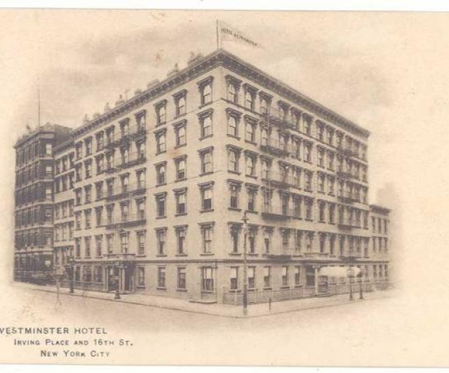 A vintage postcard featuring a historic building with a clock.