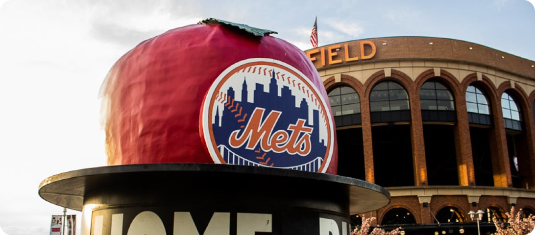 The new york mets logo is in front of the mets stadium.