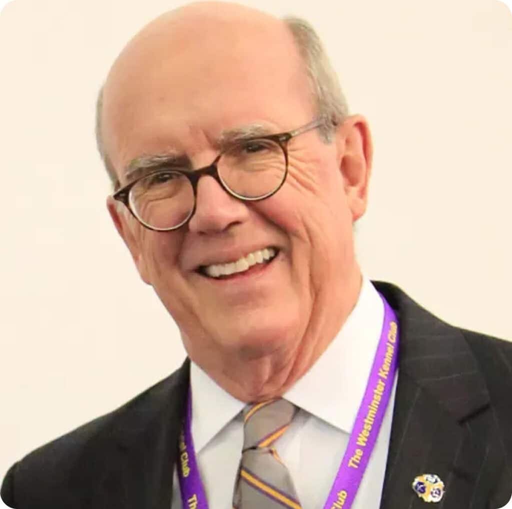 A man in a suit and tie smiling.