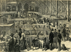 Black-and-white illustration of a crowded 19th-century exhibition hall with people viewing animals in enclosures and framed displays on the walls.