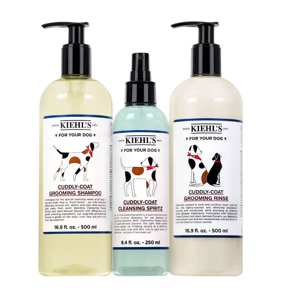 Three Kiehl's pet care products for dogs: Cuddly-Coat Grooming Shampoo, Cleansing Spritz, and Grooming Rinse, each in labeled pump bottles.